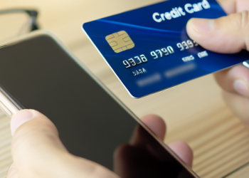 A person responsibly making a credit card payment on their smartphone