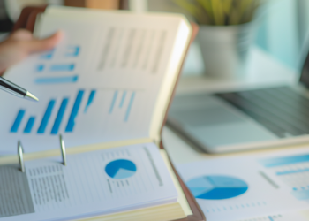 A person studying a financial report of a company in an office setting