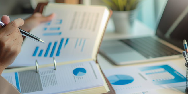 A person studying a financial report of a company in an office setting