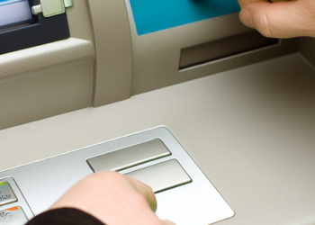 A person using an ATM machine to check balance after a credit transaction