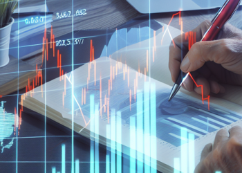 An individual studying graphs and charts on investing