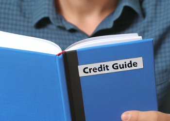 Man studying a credit score guide book