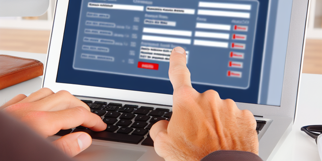 A person scrutinizing a credit report on a computer screen