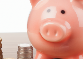 A piggy bank and coins visualizing the concept of regular saving