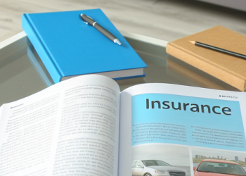 An open book on insurance basics placed on a coffee table