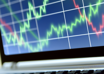 Close-up of a laptop screen displaying a line graph showing stock market trends